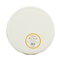 Round white bamboo tray with a yellow label on a transparent packaging, back view