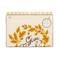Front packaging view of the folded Give Thanks canvas banner secured inside clear plastic with a yellow plaid header card.