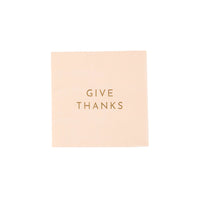 Single peach cocktail napkin with gold “GIVE THANKS” text, front view.