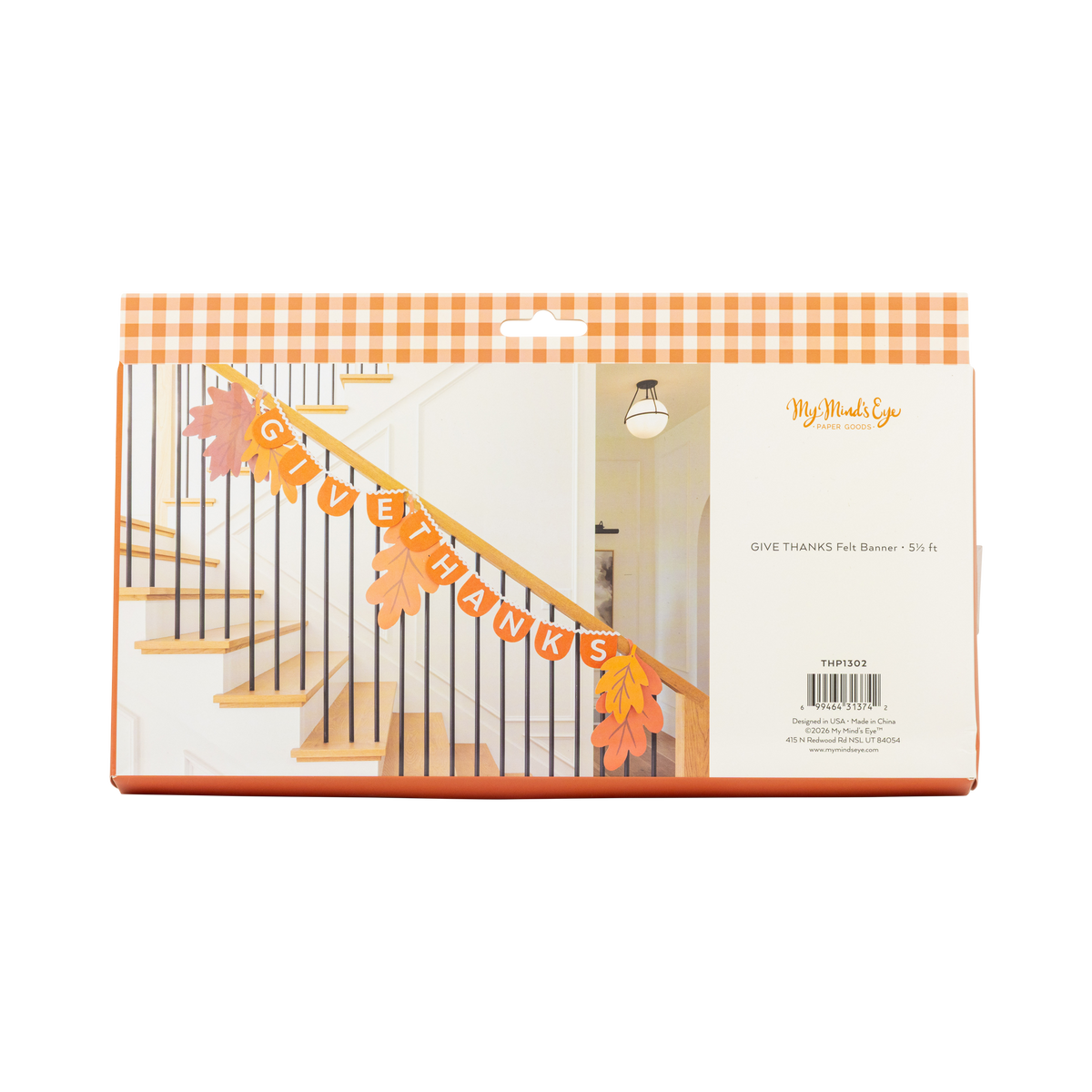 Back of orange gingham packaging showing the Give Thanks felt banner styled on a staircase with autumn leaves.
