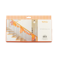 Back of orange gingham packaging showing the Give Thanks felt banner styled on a staircase with autumn leaves.