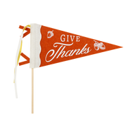"GIVE THANKS" brown felt pennant with cream script and a small pumpkin accent on a wood dowel with striped ribbon, front view on white background.