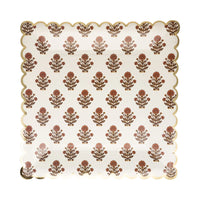 Close-up of gold trim and block-print floral artwork on paper plate.
