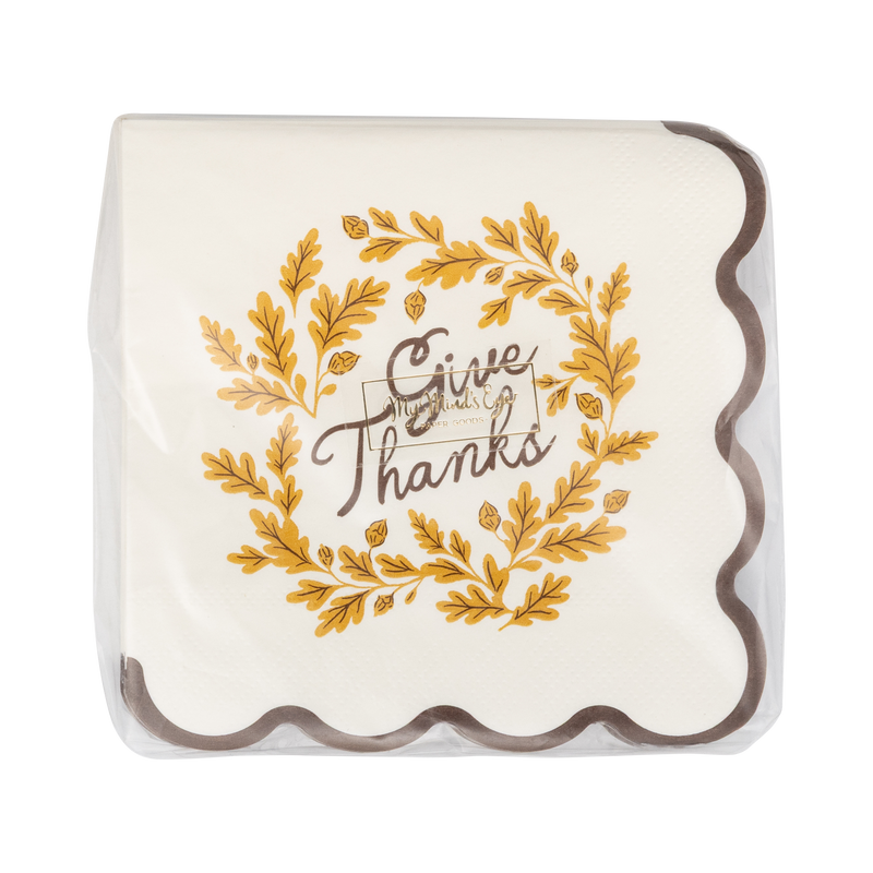Decorative paper napkin with 'Give Thanks' text and gold leaf design on a clear cover.