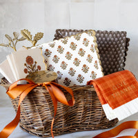 Gift basket with coordinating fall tableware and plaid “Give Thanks” napkins.
