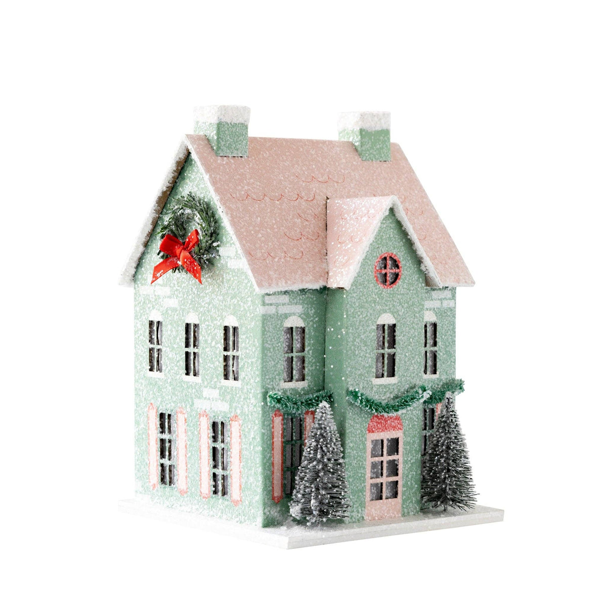 Angled view of a mint glitter house showing the wreath gable and side windows with pink shutters