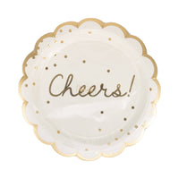 Single cream and gold Cheers scalloped dinner plate with gold foil script and dot detail shown at angle on white background