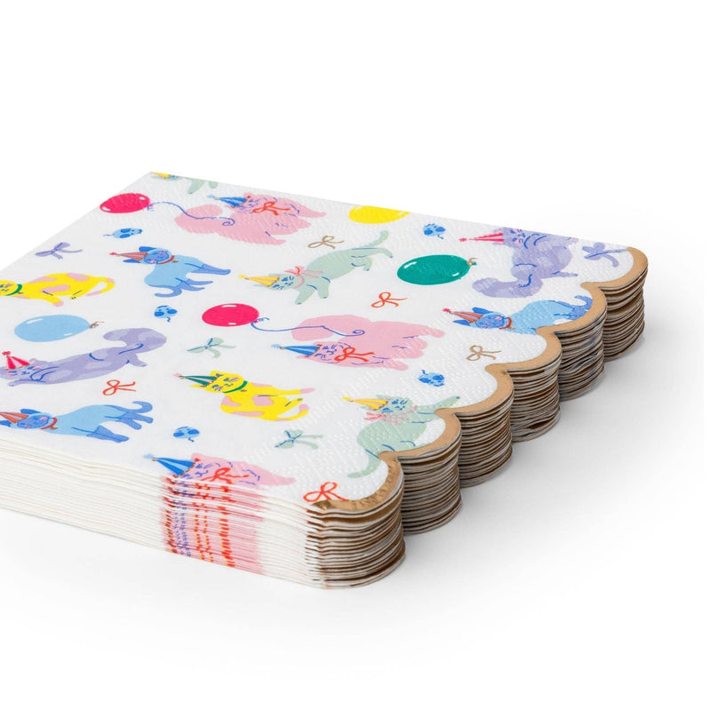 Angled studio shot showing a stack of twenty scalloped cat party napkins, highlighting the metallic gold trim along the edges.
