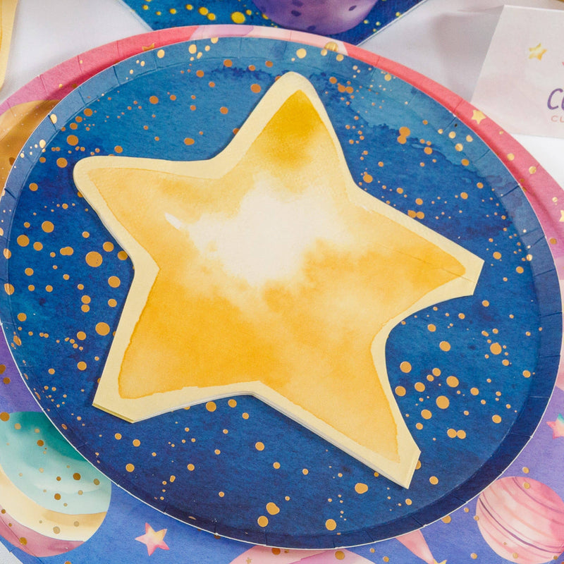 Gold star shaped napkin laid on a navy and gold galaxy plate