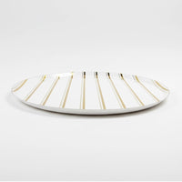 side view of gold striped paper dinner plate
