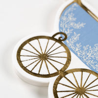 close up of gold wheel detail on carriage napkin
