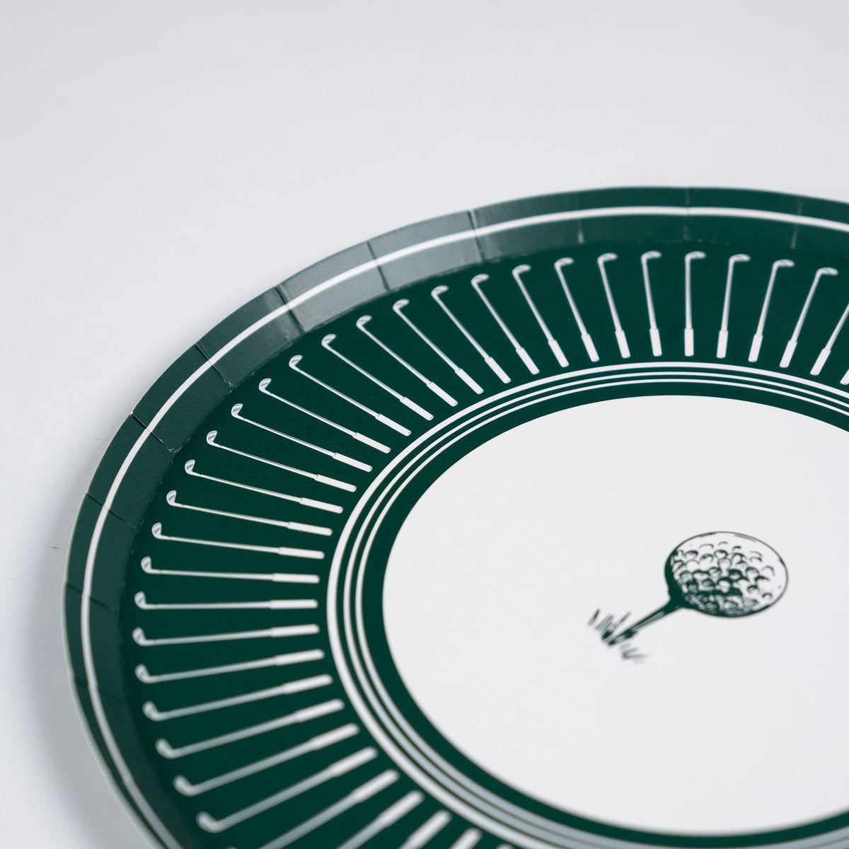 A close-up detail shot of the vintage-inspired white golf club border and topiary design on a premium green paper plate.