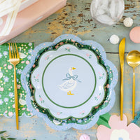 Goose plate layered with coordinating floral plates and spring table setting
