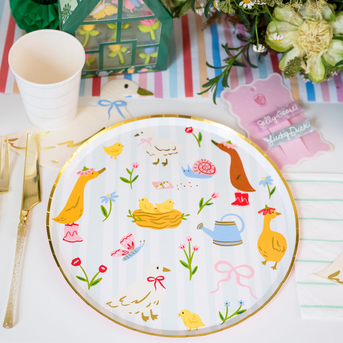 Goose themed spring party table with silly goose plate and colorful decorations.

