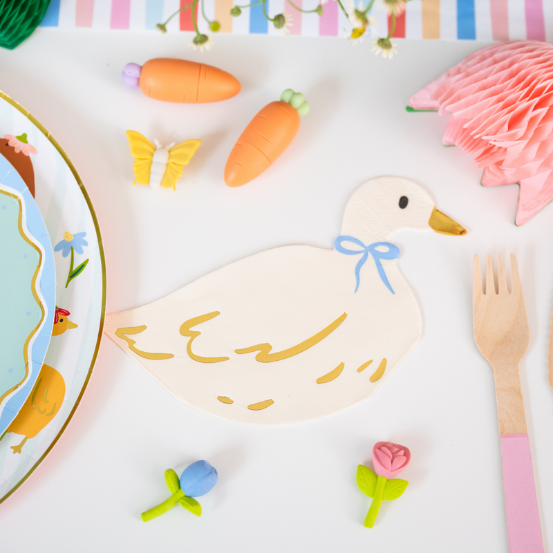 Goose shaped napkin styled with pastel Easter table decor and spring party supplies.
