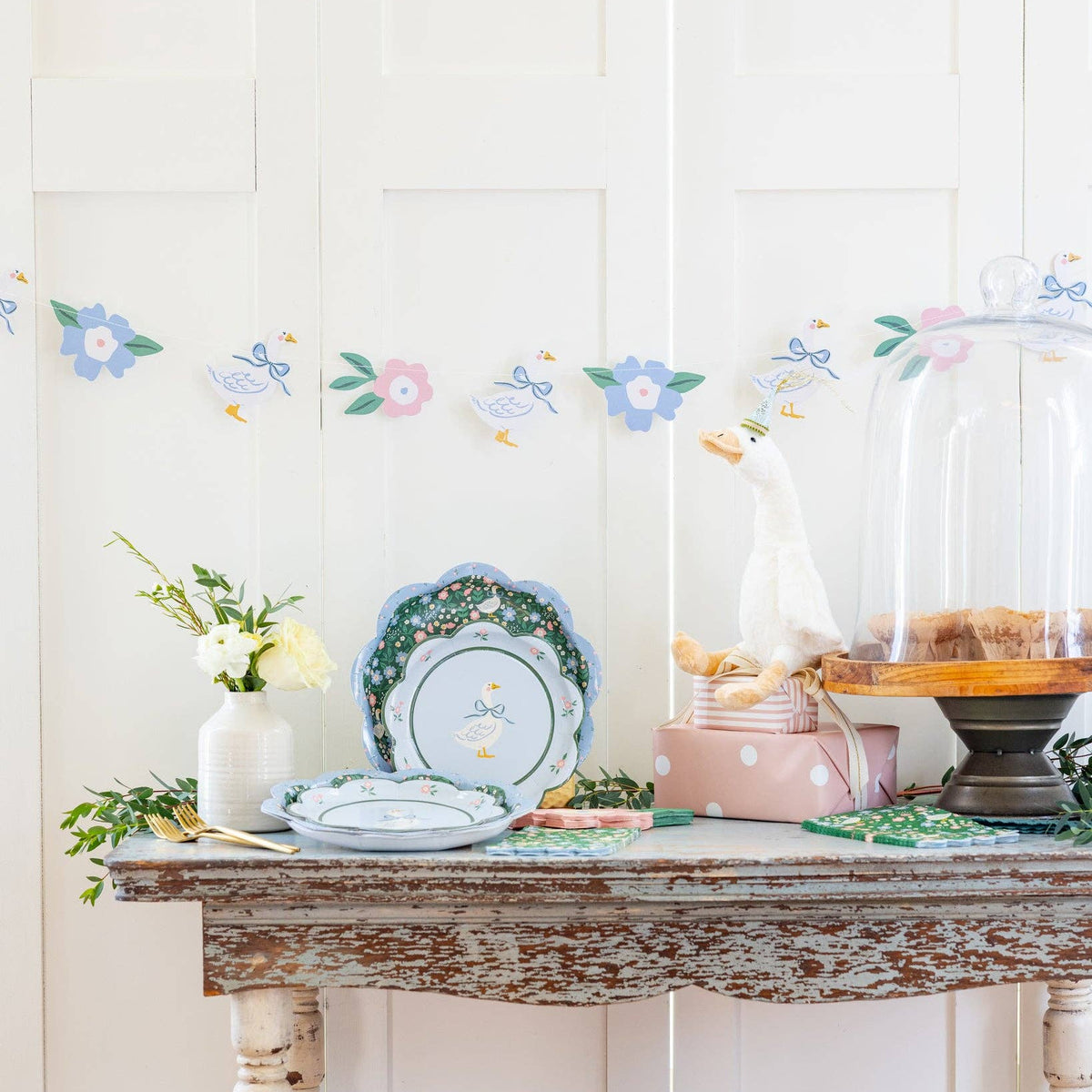 Goose party plates displayed on a spring dessert and party table setup