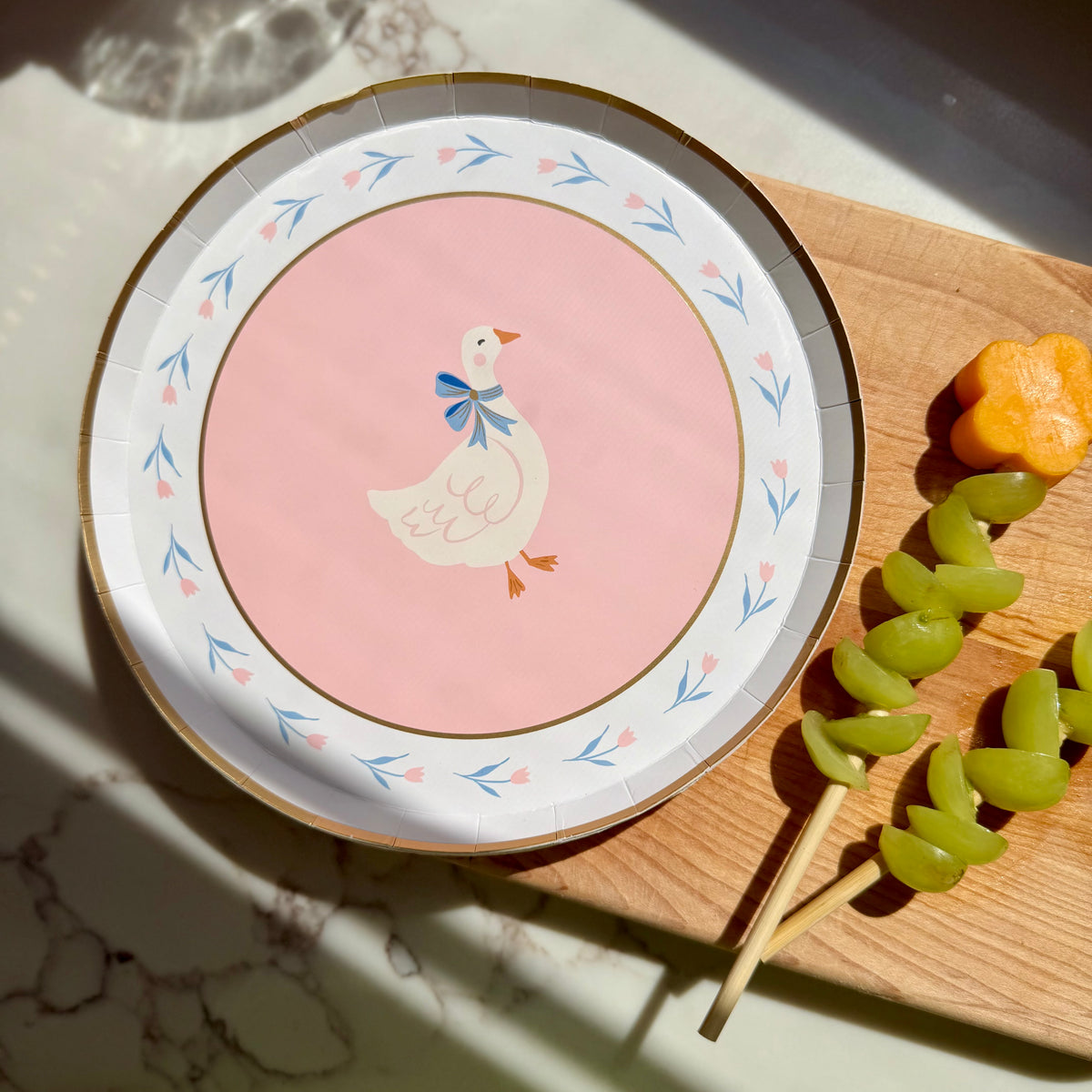 Goose paper plate grapes and carrot on a stick