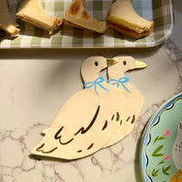 A closer view of a goose themed paper cocktail napkin. 