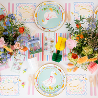 Full spring party table setup with goose themed plates and floral decorations.