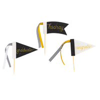 Black and cream graduation pennant cake toppers with gold lettering and ribbon accents
