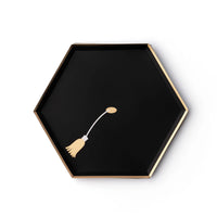 Black hexagon graduation paper snack plate with gold foil tassel design on white background
