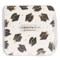 Packaged graduation cocktail napkins showing black mortarboard pattern and gold foil details