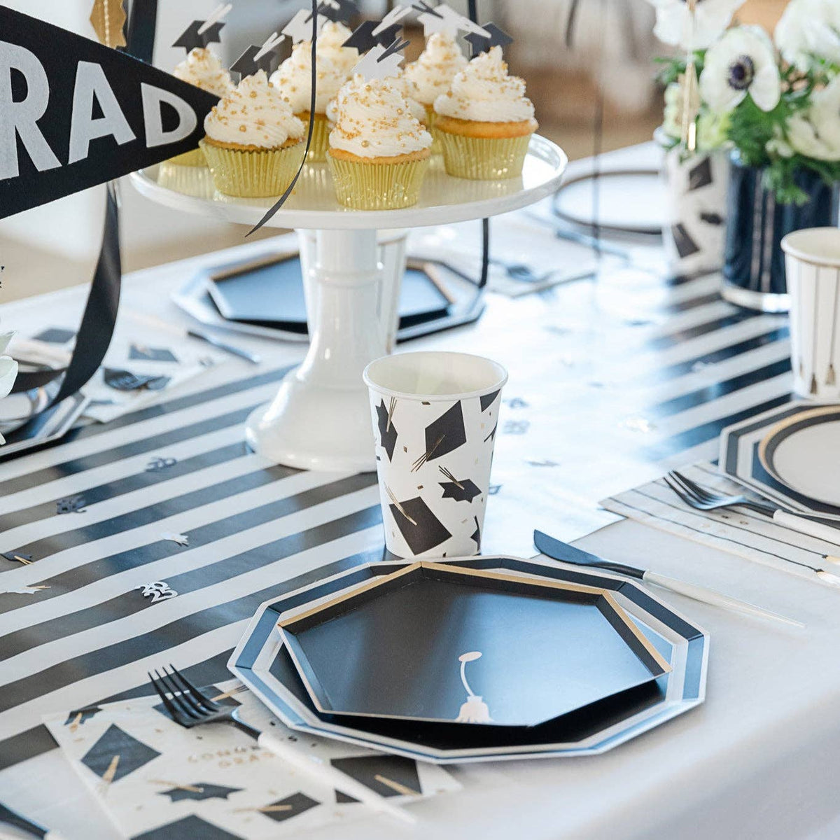 Graduation dessert table with cupcakes and black hexagon plates