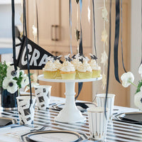 Graduation dessert table with cupcakes and grad hat toppers