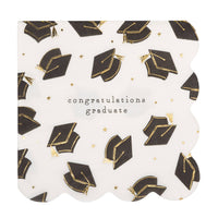 Graduation cocktail napkin with scattered black graduation caps and gold foil accents and “Congratulations Graduate” message