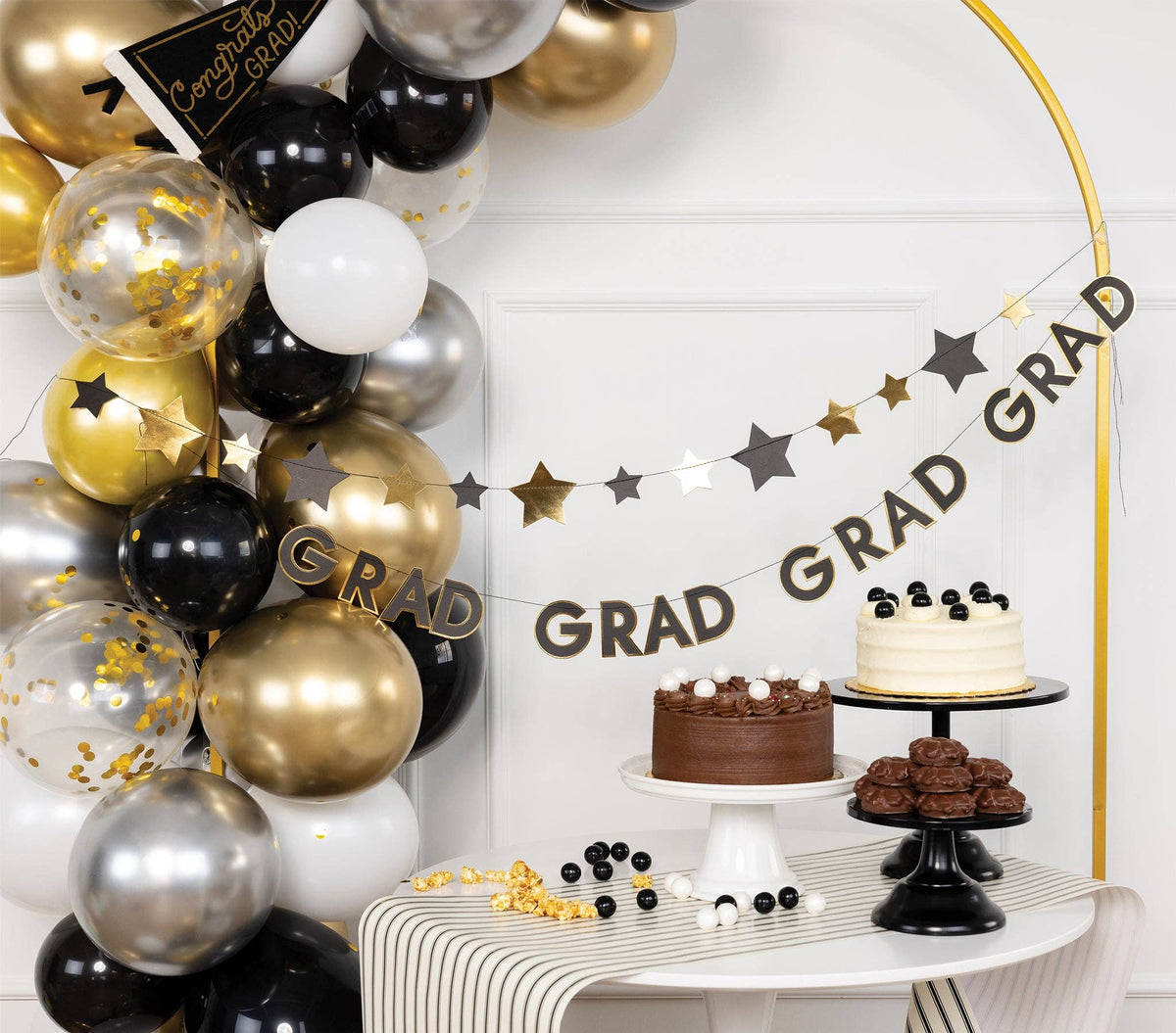 A two-strand banner stack used as a dessert bar backdrop for a Class of 2026 table decor display.