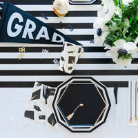 Graduation party table with black and white decor and tassel lunch napkins
