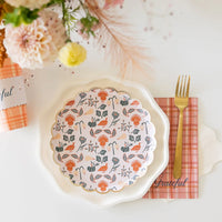 Floral salad plate on ivory charger with plaid “Grateful” guest towel to the right.