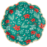 Green Christmas dinner plate with red winter florals, cream sprigs, gold stars, and a swan on a rich green base with a gold-trimmed scalloped rim, overhead view on white background.