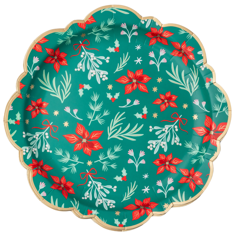 Green Christmas dinner plate with red winter florals, cream sprigs, gold stars, and a swan on a rich green base with a gold-trimmed scalloped rim, overhead view on white background.