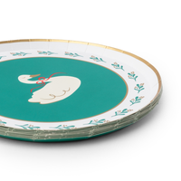 Stack of green swan Christmas paper dessert plates showing the gold-trimmed rim and swan design from an angle.