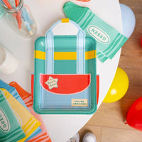 Green crayon shaped napkin with backpack plate