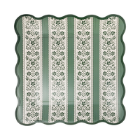 Square green and cream floral stripe paper plate with a wavy green scalloped edge on a white background