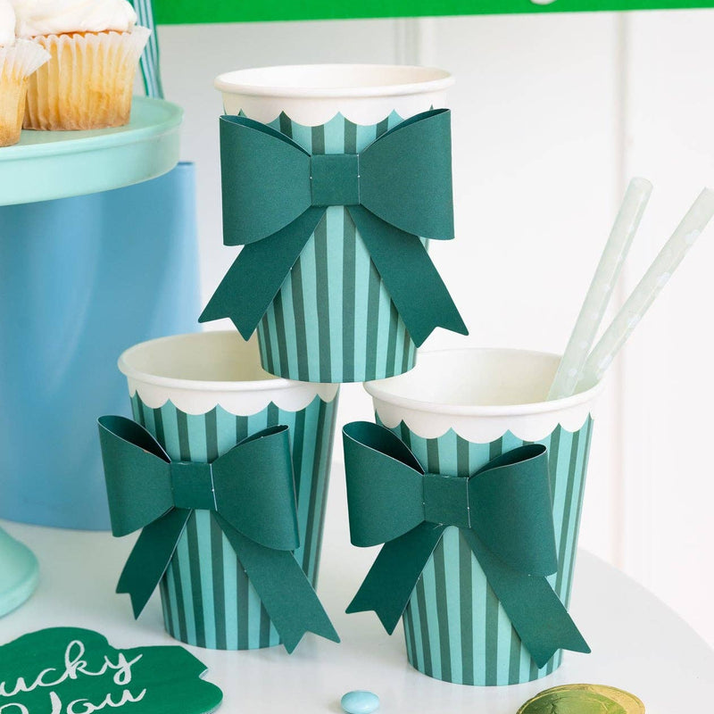 Green and mint bow party cups styled on a dessert table for a St. Patrick’s Day party.