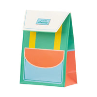 Green and yellow backpack-shaped treat bag angled view.