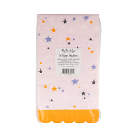 Back of Groovy Stars halloween napkins pack showing barcode and label over pastel pink paper dotted with multicolor stars and marigold fringe edge.