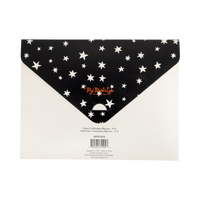 Back of the packaging — black background with white stars and product details.