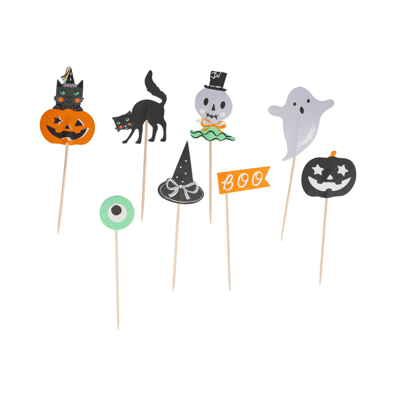 Halloween-themed cupcake toppers on sticks with various designs including a cat, ghost, and witch hat.
