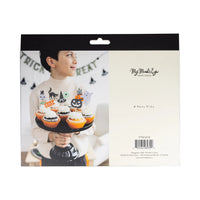 Retail package back showing boy holding cupcakes decorated with Halloween toppers in front of Trick or Treat banner.