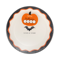 Stacked Halloween dessert plates showing the layered edges and a top plate with the bat "trick or treat" design, angled view.