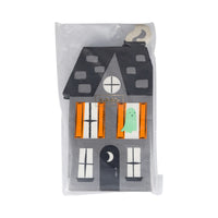Front packaging of die-cut Haunted Mansion paper napkins with orange window shutters.