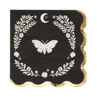 Black Halloween cocktail napkin with a cream moth illustration inside a cream laurel wreath frame and crescent moon, gold foil scalloped edge, overhead view on gray background.