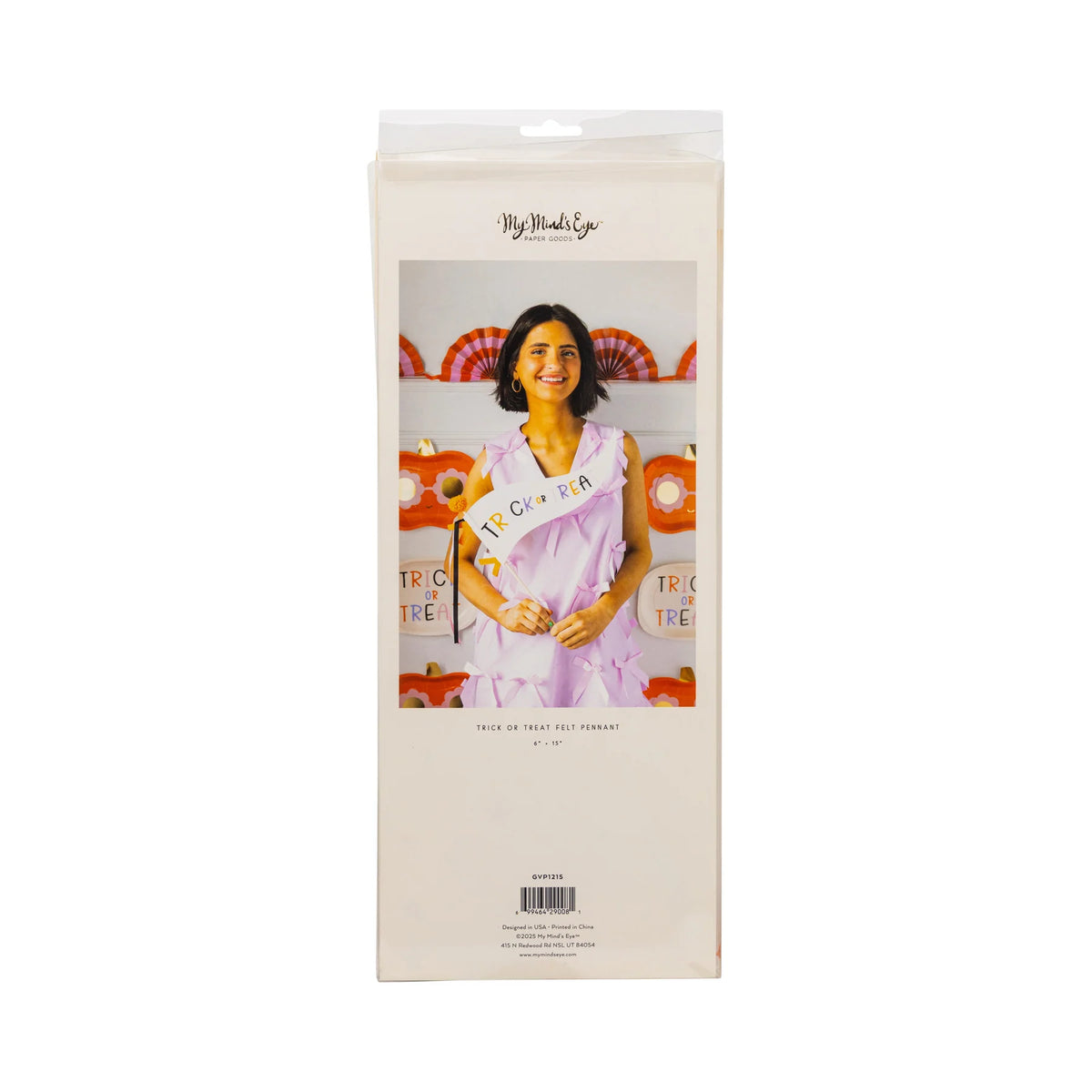 Back of Groovy Pumpkin Halloween pennant package showing smiling woman holding the cream felt “Trick or Treat” halloween flag amid orange pumpkin party décor.