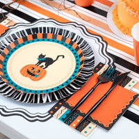 Halloween place setting with the retro striped towel, vintage cat plate, orange napkins, and black flatware.