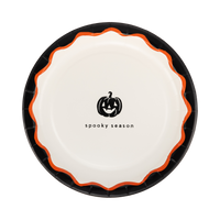 Cream Halloween plate with a black pumpkin icon and "spooky season" text, black rim and orange scalloped edge.