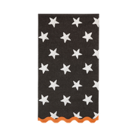 Black Halloween paper guest towel with white stars and an orange scalloped edge, shown folded on white